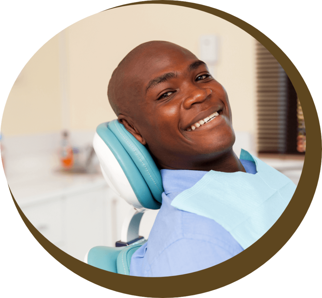 African American man smiles in the dentist chair at his Midlothian dentist, Cedarwood Dentistry.
