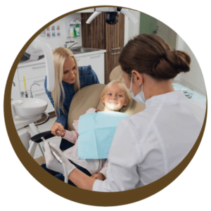 Child smiles in dental chair with her mother beside her since financing dental care in Midlothian, VA is easy at Cedarwood Dentistry.