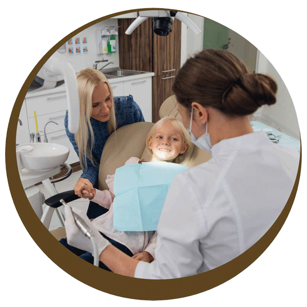 Child smiles in dental chair with her mother beside her since financing dental care in Midlothian, VA is easy at Cedarwood Dentistry.