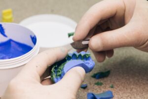 dental technician making a set of temporary veneers