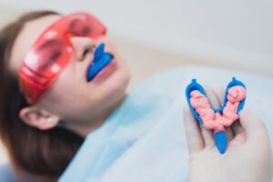 girl getting fluoride treatment at dentist