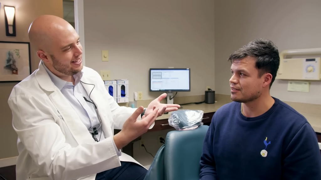 Dr. Chris Wolberg explains a dental procedure to a patient in his Midlothian, VA, dental office.