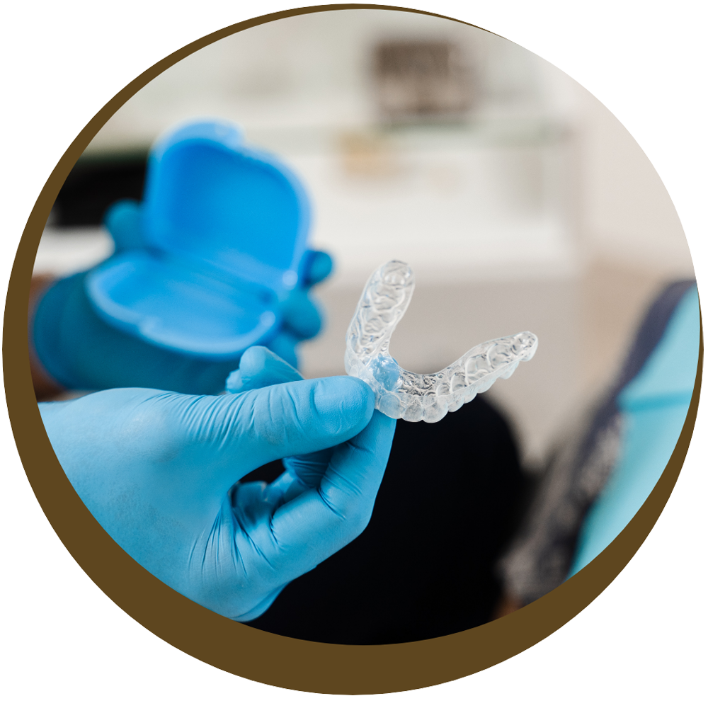 Teeth whitening dentist, Dr. Wolberg, holds a whitening tray up to show patients what the process of whitening teeth looks like at Cedarwood Dentistry.