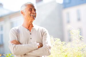 A senior man smiles after visiting a dentist that understands how to best provide for the changing dental needs of older adults.