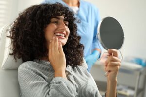 woman admiring her new Veneers